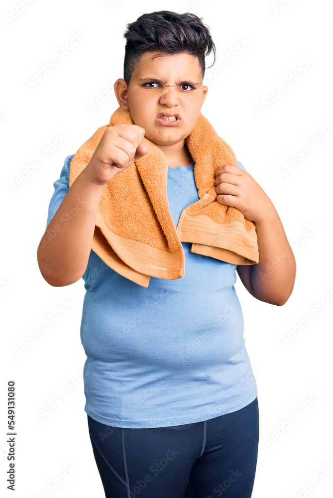 Little boy kid wearing sportswear and towel annoyed and frustrated shouting with anger, yelling crazy with anger and hand raised Little boy kid wearing sportswear and towel annoyed and frustrated shouting with anger, yelling crazy with anger and hand raised