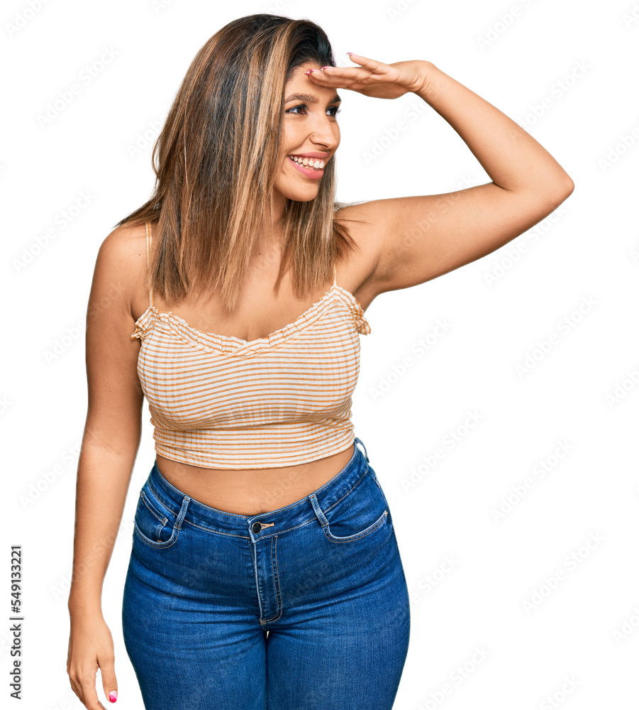 Beautiful brunette woman wearing casual clothes very happy and smiling looking far away with hand over head. searching concept. Beautiful brunette woman wearing casual clothes very happy and smiling looking far away with hand over head. searching concept.