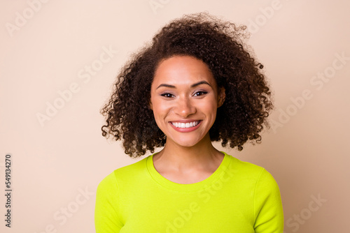 Close up photo of young lovely lady curly hair toothy smiling businesswoman wear stylish yellow look isolated on beige color background © deagreez