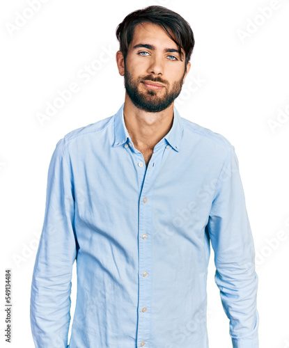 Canvas Print Hispanic man with blue eyes wearing business shirt looking sleepy and tired, exhausted for fatigue and hangover, lazy eyes in the morning