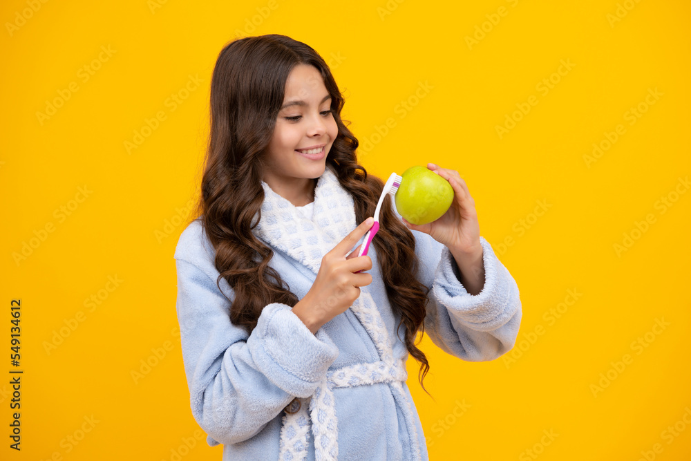Girl cleaning teeth. Apple vitamins for healthy teeth. Kid brushing teeth with brush. Dental hygiene, tooth care. Girl cares about health of his teeth. Girl cleaning teeth. Apple vitamins for healthy teeth. Kid brushing teeth with brush. Dental hygiene, tooth care. Girl cares about health of his teeth.