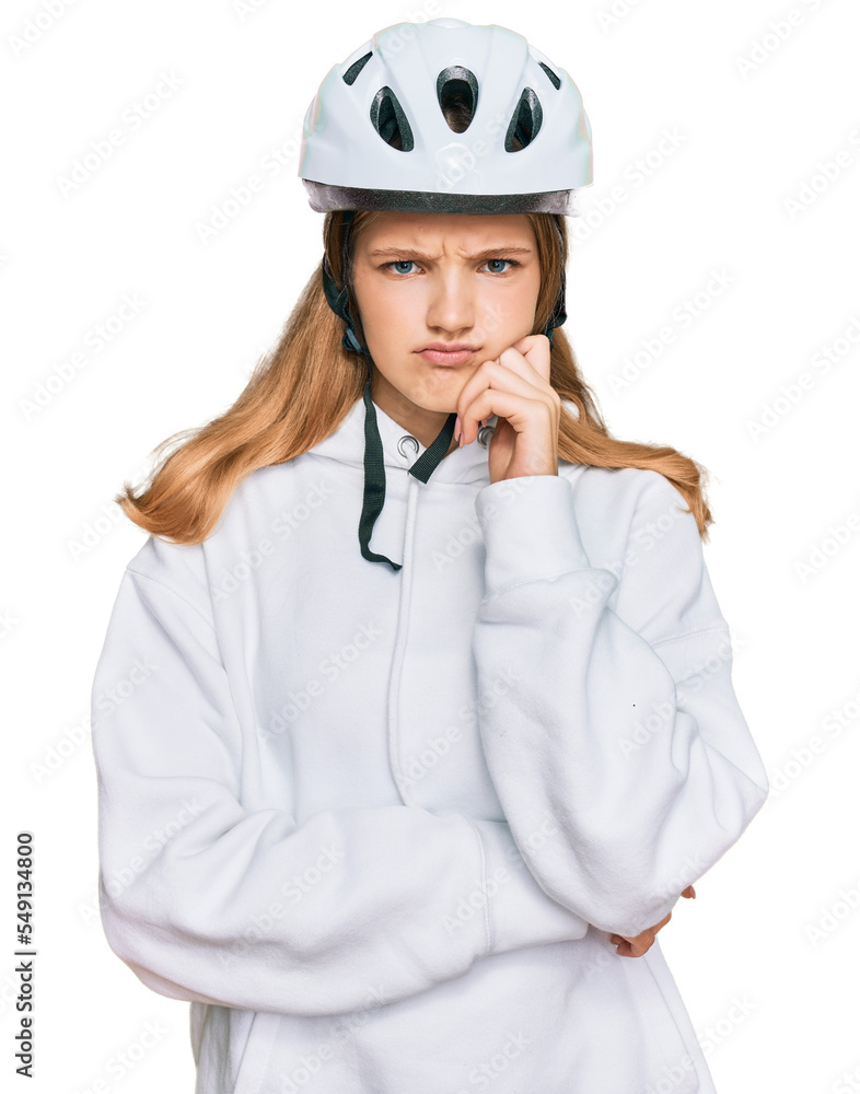 Beautiful young caucasian girl wearing bike helmet serious face thinking about question with hand on chin, thoughtful about confusing idea Beautiful young caucasian girl wearing bike helmet serious face thinking about question with hand on chin, thoughtful about confusing idea