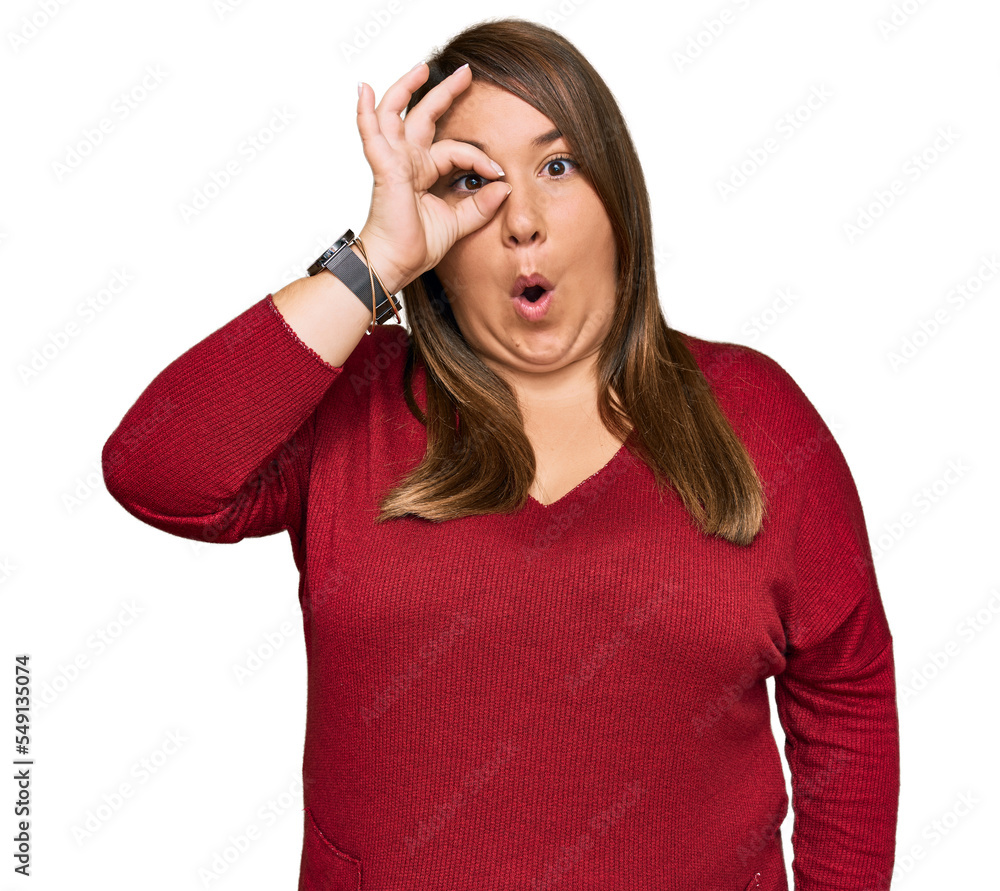 Beautiful brunette plus size woman wearing casual clothes doing ok gesture shocked with surprised face, eye looking through fingers. unbelieving expression. Beautiful brunette plus size woman wearing casual clothes doing ok gesture shocked with surprised face, eye looking through fingers. unbelieving expression.