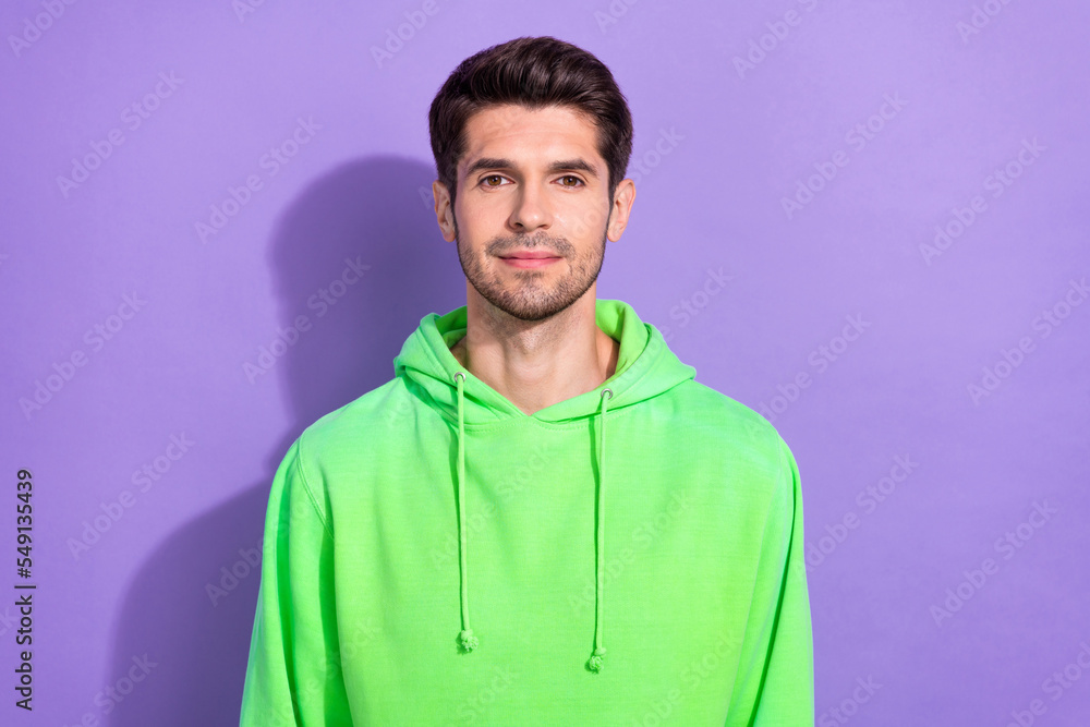 Photo of confident attractive handsome guy with brunet hairdo dressed green hoodie look at camera isolated on purple color background Photo of confident attractive handsome guy with brunet hairdo dressed green hoodie look at camera isolated on purple color background