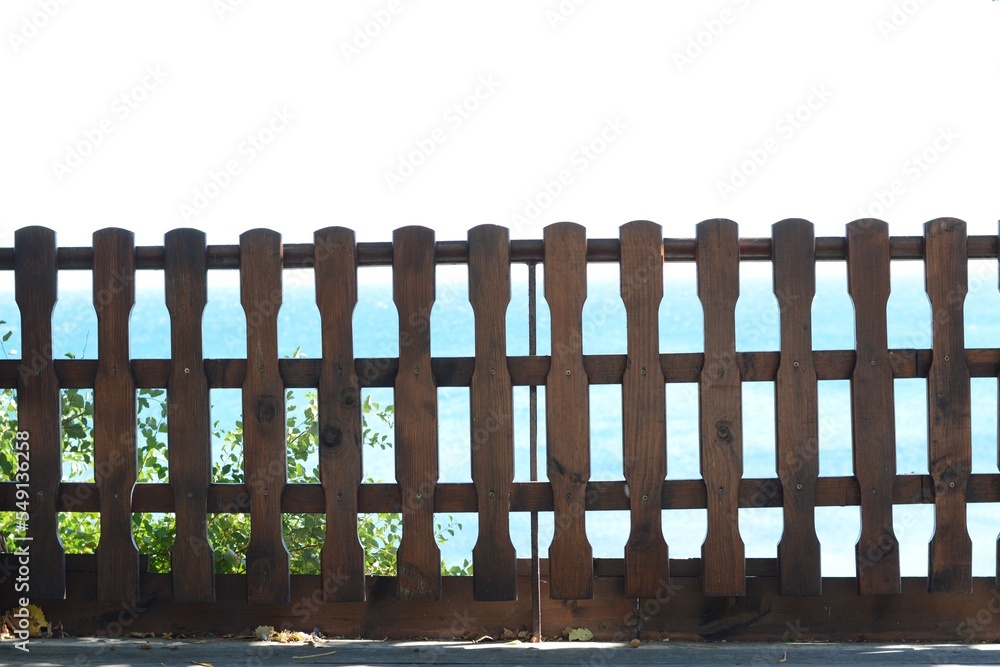Wooden fence against sky on sunny day outdoors Wooden fence against sky on sunny day outdoors