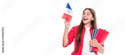travel to france. learn foreign language. surprised teen girl hold french flag and workbook. Horizontal isolated poster of school girl student. Banner header portrait of schoolgirl copy space.