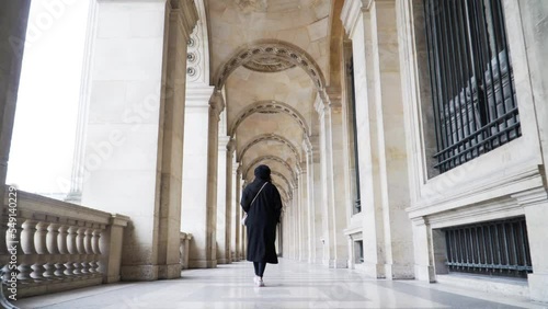 Woman Walking Through The Archways At Louvre Museum In Paris, France. - Follow Shot, Low-Angle