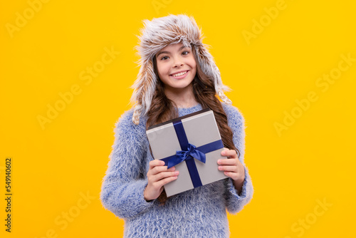 Obraz na plátně glad teen girl wear earflap hat with purchase ox on yellow background, anniversa
