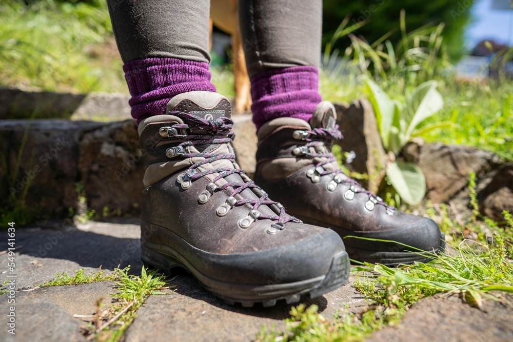 Tying shoelaces on hiking boots by a girl on a hike Tying shoelaces on hiking boots by a girl on a hike