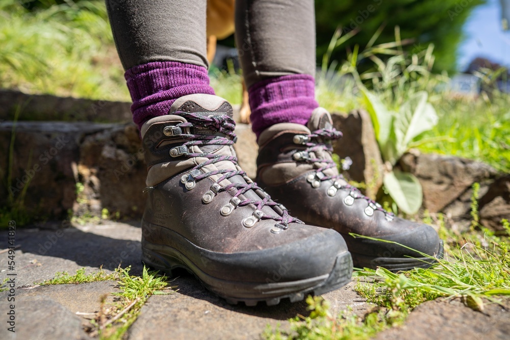 Tying shoelaces on hiking boots by a girl on a hike Tying shoelaces on hiking boots by a girl on a hike