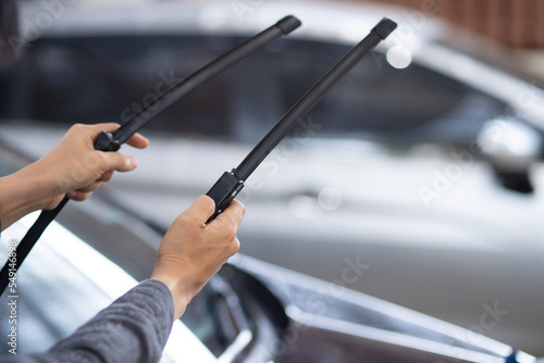 Technician replacing windshield wipers change car wiper blades