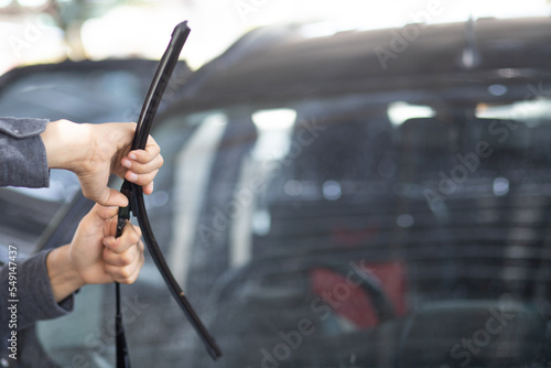 Technician replacing windshield wipers change car wiper blades