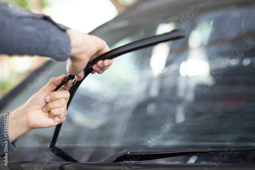 Fotografija Technician replacing windshield wipers change car wiper blades