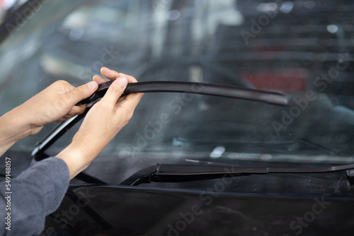 Technician replacing windshield wipers change car wiper blades