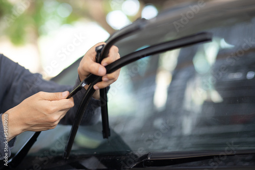 Technician replacing windshield wipers change car wiper blades