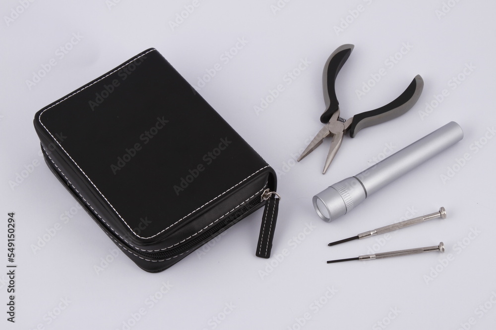 Various tools and a small stitched case Various tools and a small stitched case