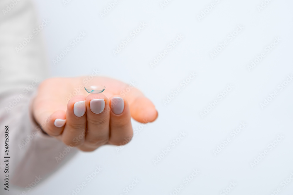 Contact lens in woman hands with copy space. Healthcare and eye care concept. Contact lens in woman hands with copy space. Healthcare and eye care concept.