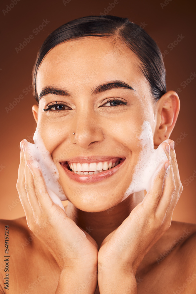 Hands with foam on face, beauty with woman and cosmetic product, cleaning and moisturizer with facial and happy in portrait. Skincare, clean skin and wellness with soap against studio background. Hands with foam on face, beauty with woman and cosmetic product, cleaning and moisturizer with facial and happy in portrait. Skincare, clean skin and wellness with soap against studio background.