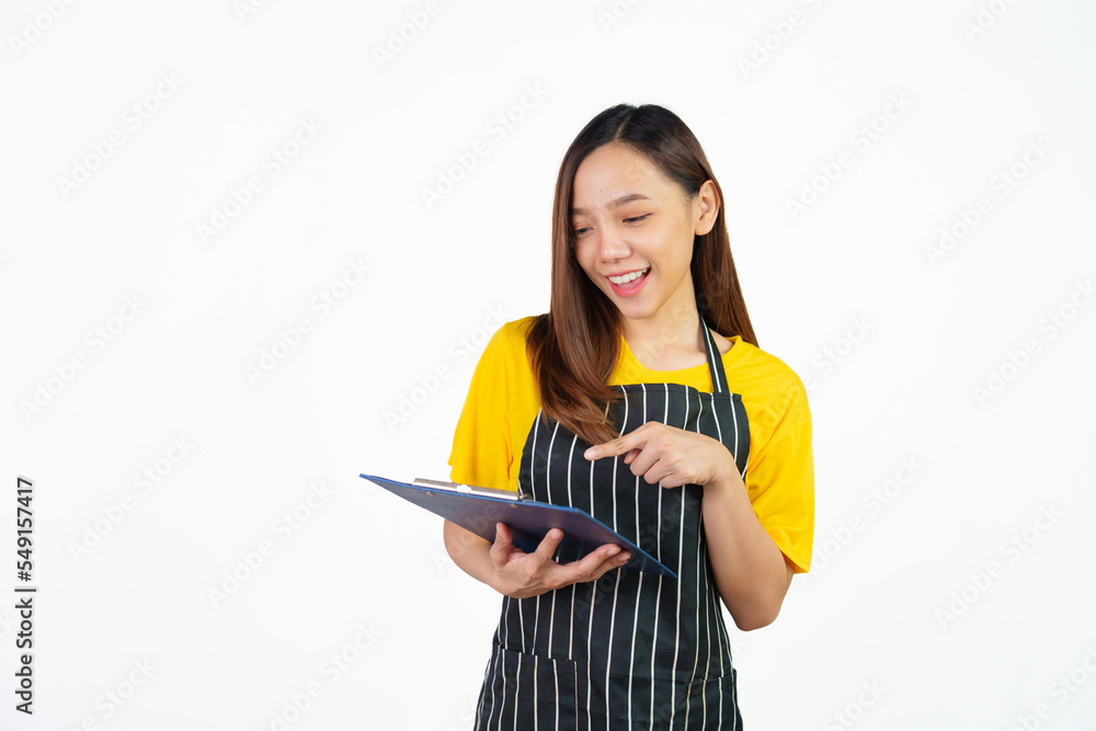 Holding menu on clipboard, Portrait of confident asian woman barista and food owner shop with yellow t-shirt and black apron standing on white background. Holding menu on clipboard, Portrait of confident asian woman barista and food owner shop with yellow t-shirt and black apron standing on white background.