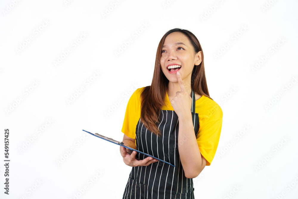 Holding menu on clipboard, Portrait of confident asian woman barista and food owner shop with yellow t-shirt and black apron standing on white background. Holding menu on clipboard, Portrait of confident asian woman barista and food owner shop with yellow t-shirt and black apron standing on white background.