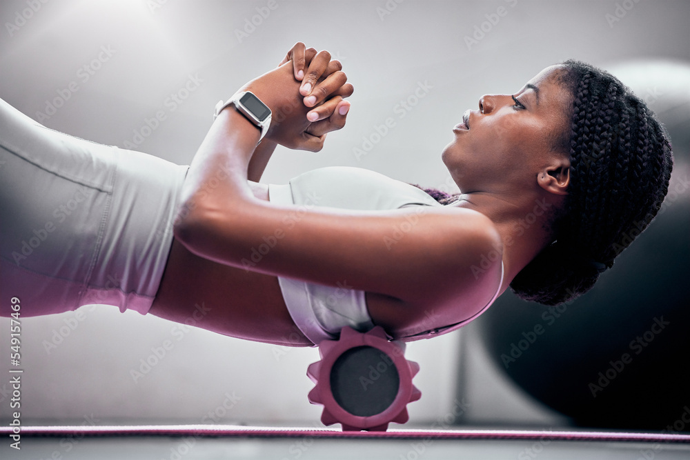 Yoga, floor and black woman with foam roller for massage, healthcare or  back support help in
