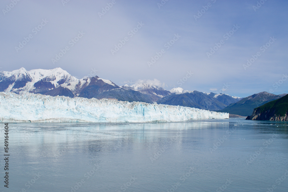 alaska mountains and glacier at water's edge blue skies