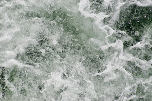 water churning in a wake and foaming