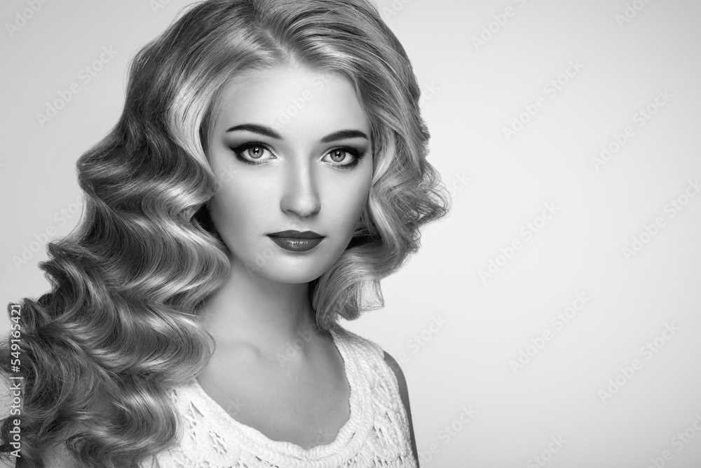 Fototapeta premium Beautiful girl with long wavy and shiny hair . Blonde woman with curly hairstyle. Perfect make-up. Fashion photo. Black and White photo