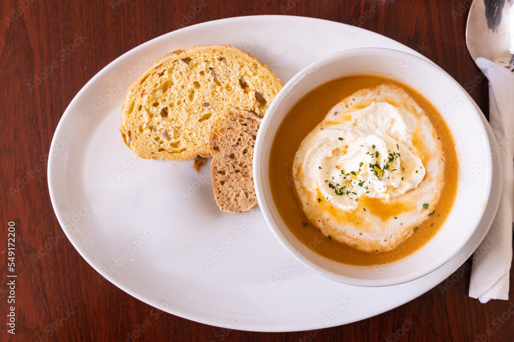 Overhead view of Icelandic lobster soup, a delicacy in Iceland. Served with bread, it is creamy and delicious Overhead view of Icelandic lobster soup, a delicacy in Iceland. Served with bread, it is creamy and delicious