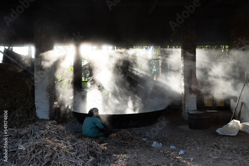 Sugar cane manufacturing unit or kitchen where they extract the juice out of Sugar cane and boil them and convert it in to sugar photo