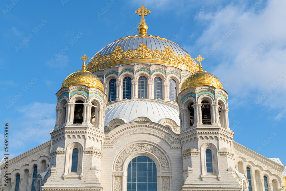 The dome of the Naval Cathedral of St. Nicholas the Wonderworker (1913) against the blue sky on a sunny day. Kronstadt, Russia