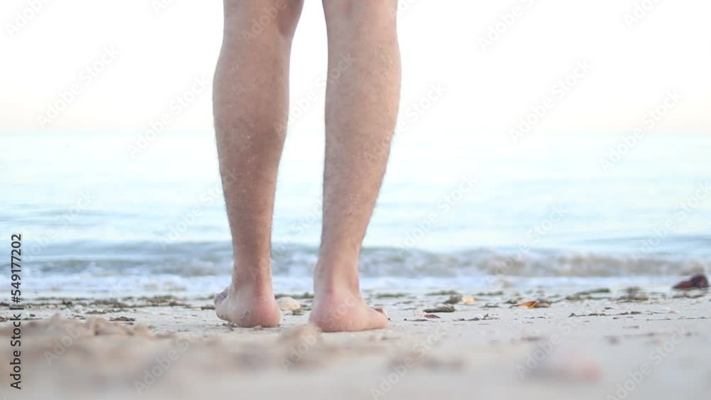 Barefoot male legs stand on the wet coastal sand on the shores of Puerto Progreso yucatan, mexico Barefoot male legs stand on the wet coastal sand on the shores of Puerto Progreso yucatan, mexico