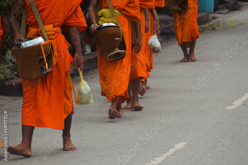 Buddhist monks during Sai Bat or Tak Bat, the traditional morning alms giving ceremony in Luang Prabang, Laos