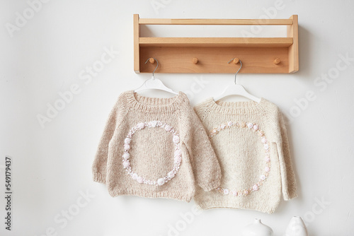 Baby knitted clothes. Handmade knitted clothes with embroidery.