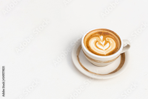 A cup of hot latte art or cappuccino coffee on white background