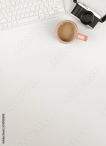 flat lay of computer keyboard, digital camera and a cup of coffee on white background. A4 size