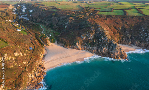 Aerial drone landscape image of Minnack Theatre headland around Porthcurno beach in Cornwall England at dawn photo