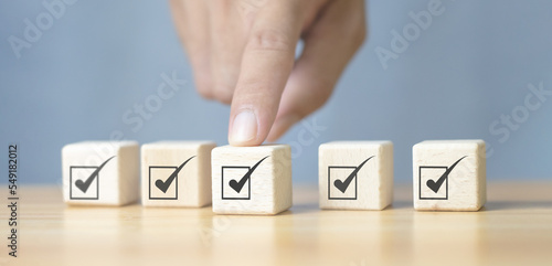 Corporate Compliance Quality control management, ISO certification, product quality service guarantee. Assessment Enter a wooden cube with a check mark icon.