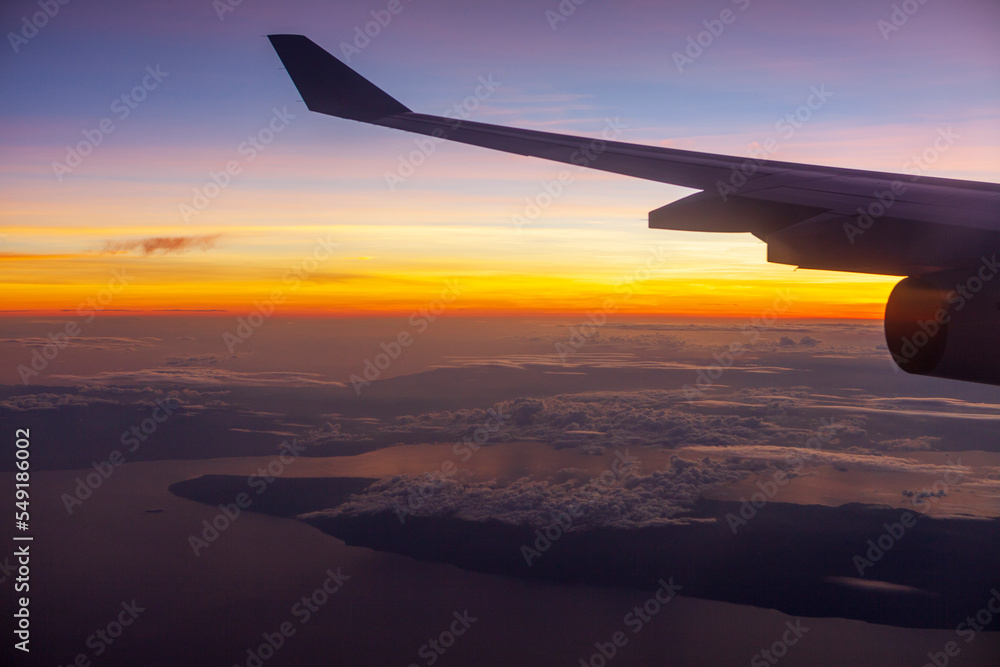 Wing of airplane in flight at Dawn Wing of airplane in flight at Dawn