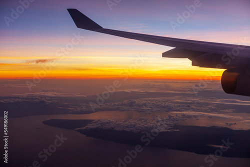 Wing of airplane in flight at Dawn