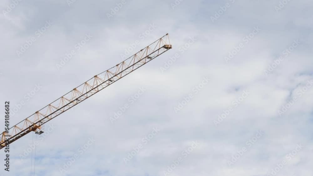 construction crane moves against the background of the sky construction crane moves against the background of the sky