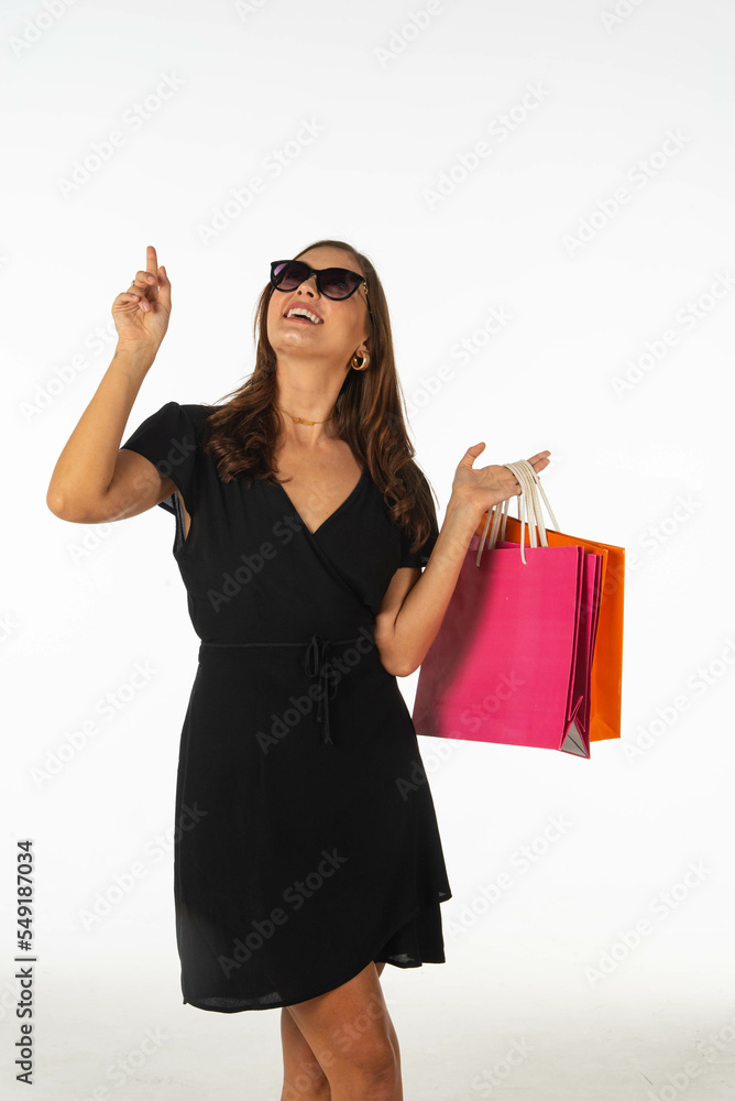Young beautiful woman holding shopping bag on isolated white background Young beautiful woman holding shopping bag on isolated white background