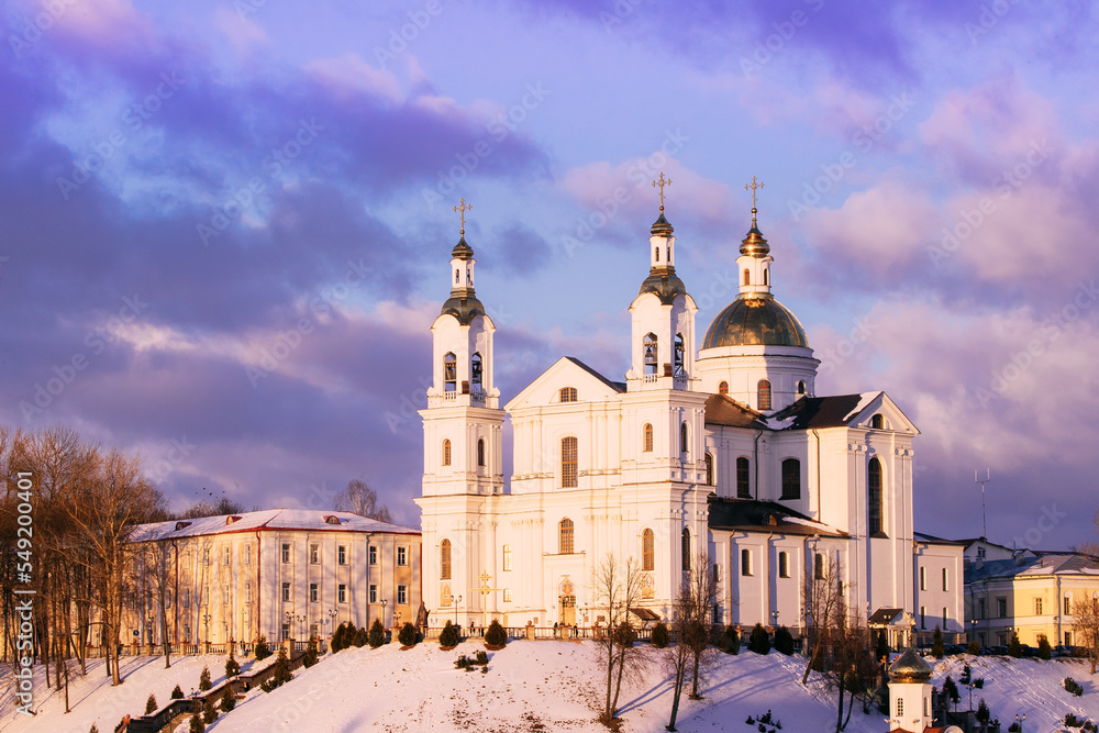 Vitebsk, Belarus. Morning View Of Famous Landmark Is Assumption Cathedral Church In Upper Town On Uspensky Mount Hill In Sunrise Illumination. Soft Colors. Cathedral On Background Toned Cloudy Sky.