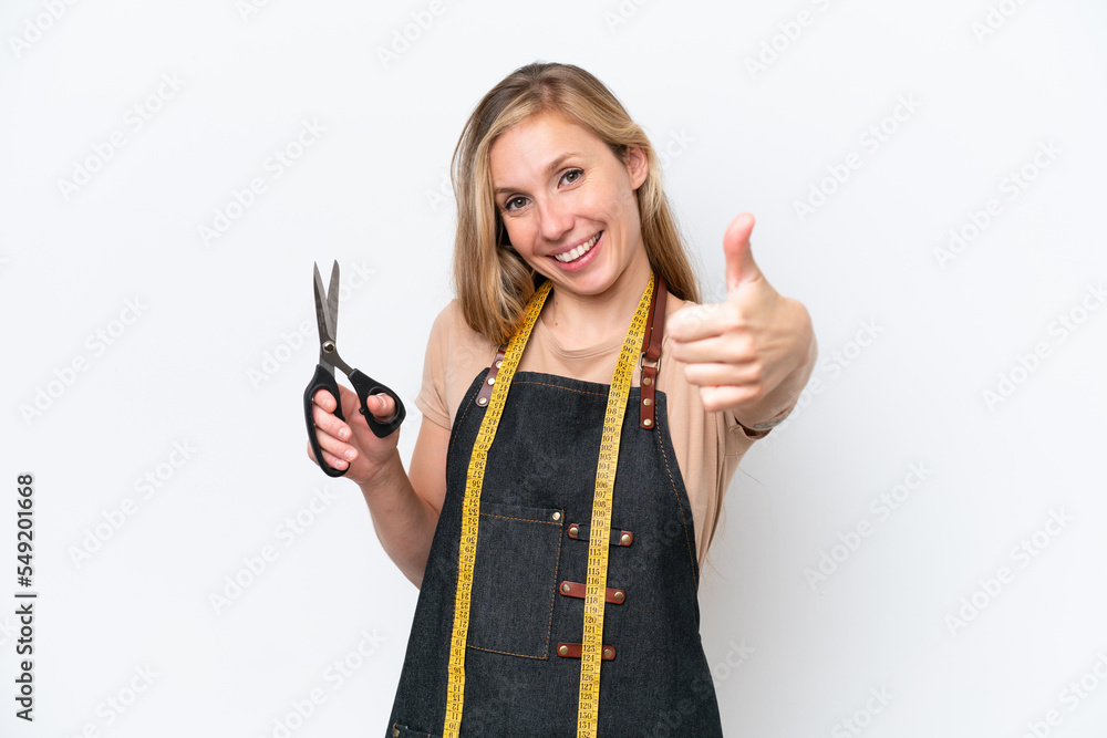 Young blonde seamstress woman isolated on white background with thumbs up because something good has happened Young blonde seamstress woman isolated on white background with thumbs up because something good has happened