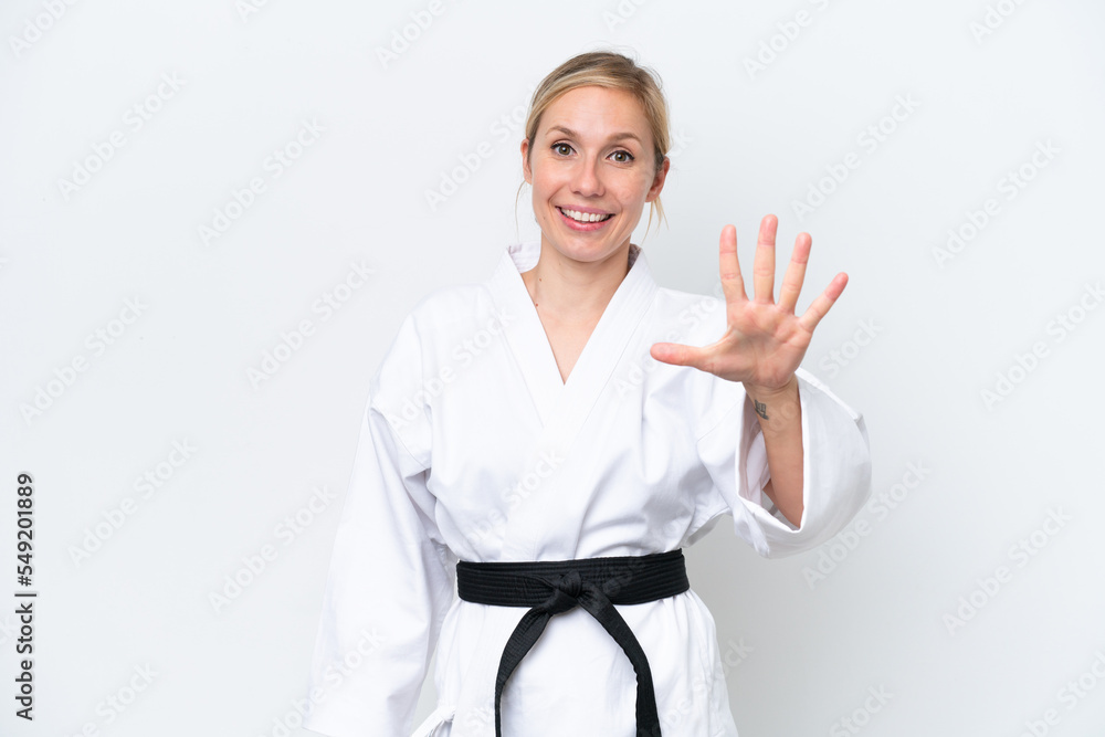 Young caucasian woman doing karate isolated on white background counting five with fingers Young caucasian woman doing karate isolated on white background counting five with fingers
