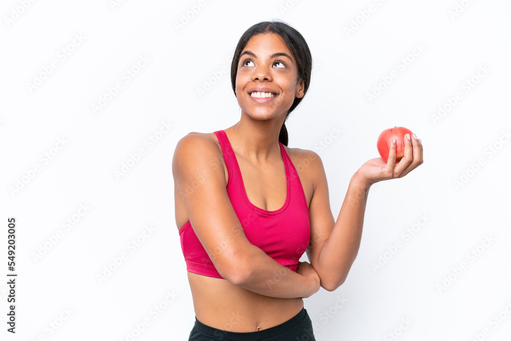 Young African american woman isolated on white background with an apple and happy Young African american woman isolated on white background with an apple and happy