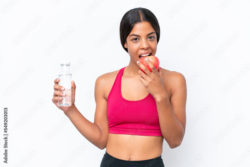 Young African american woman isolated on white background with a bottle of water and eating an apple Young African american woman isolated on white background with a bottle of water and eating an apple