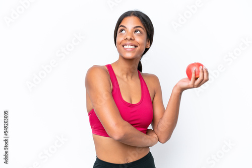 Young African american woman isolated on white background with an apple and happy