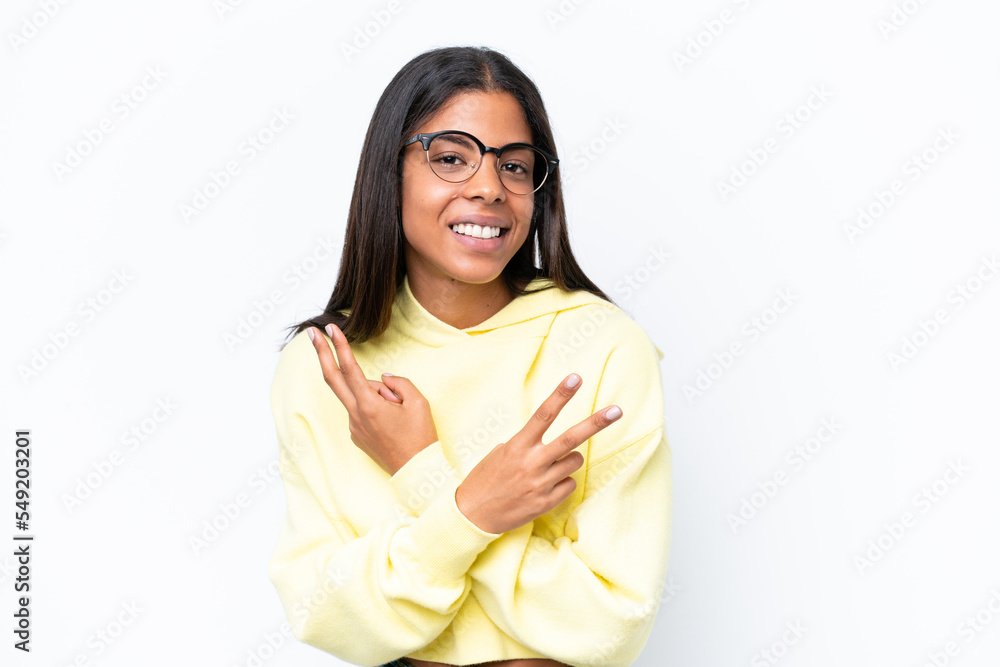 Young African american woman isolated on white background smiling and showing victory sign Young African american woman isolated on white background smiling and showing victory sign