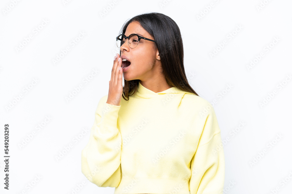 Young African american woman isolated on white background yawning and covering wide open mouth with hand Young African american woman isolated on white background yawning and covering wide open mouth with hand